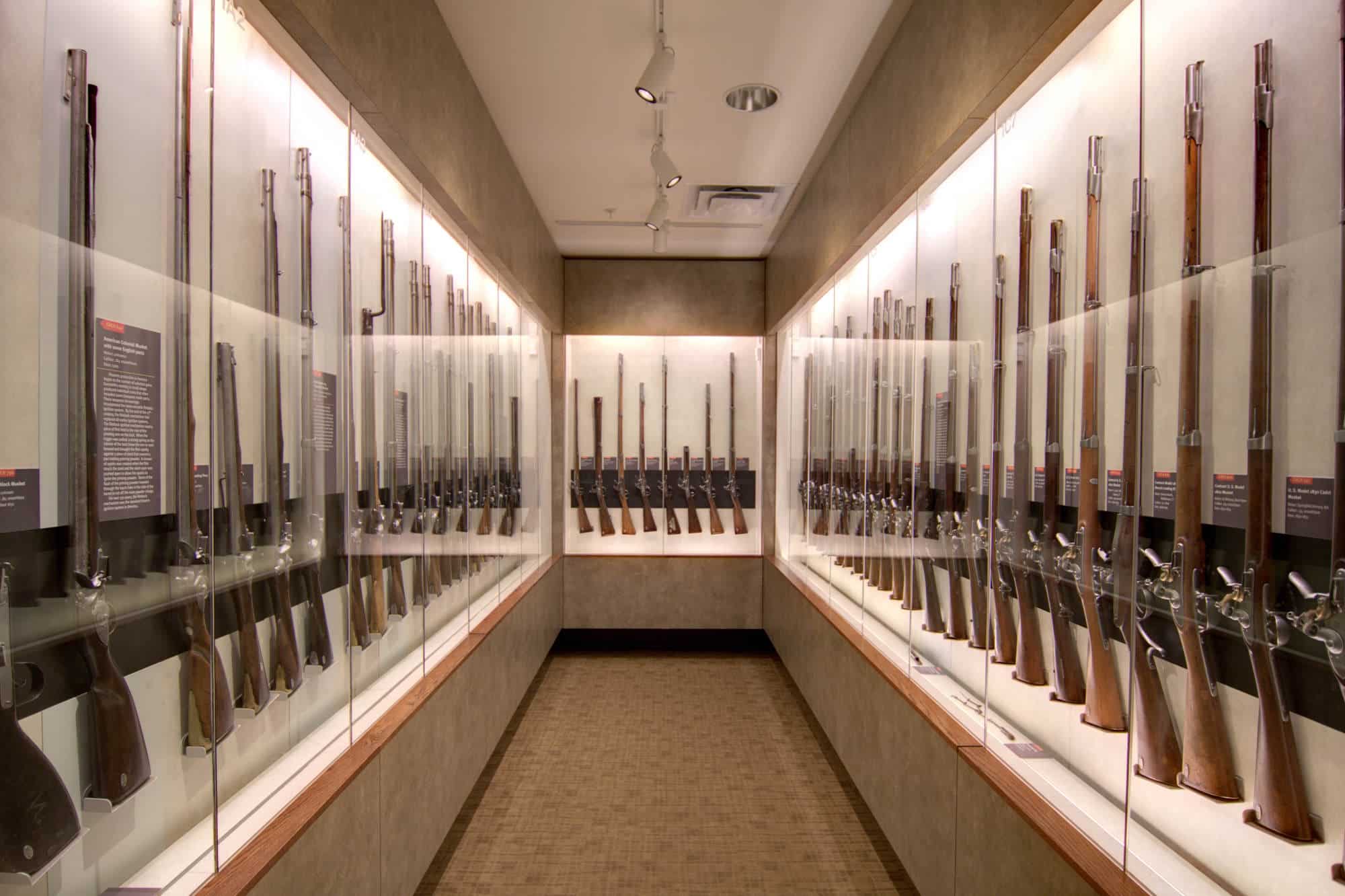 Glass cases filled with antique guns