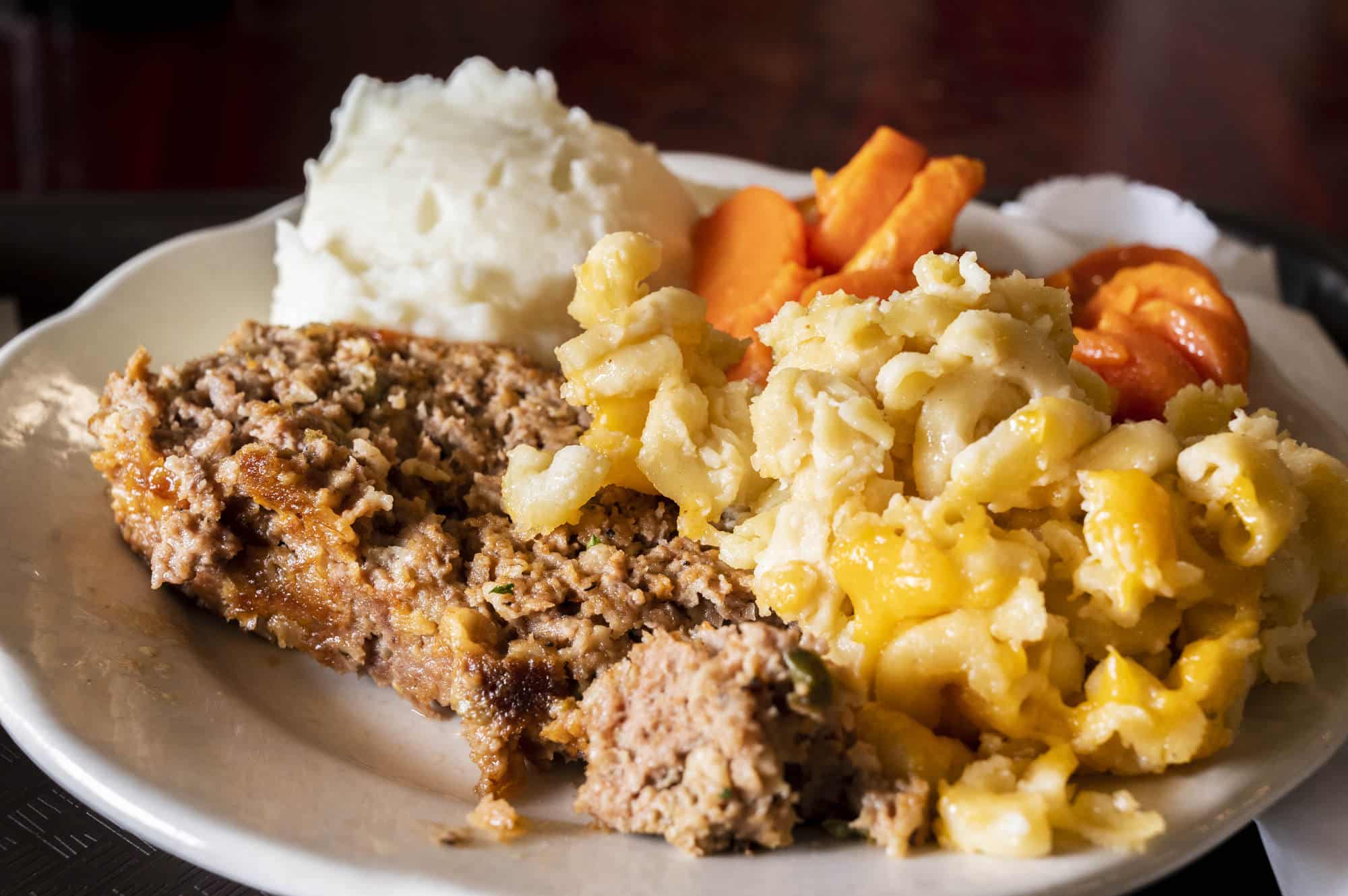 Plate of food with fried chicken, macaroni and cheese, mashed potatos, and baked carrots at Miller's Bread Basket in Blackville, South Carolina.