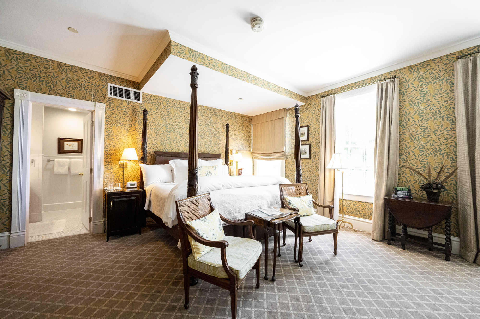 A four-poster queen bed dominates the large room at The Willcox boutique hotel in Aiken, South Carolina.